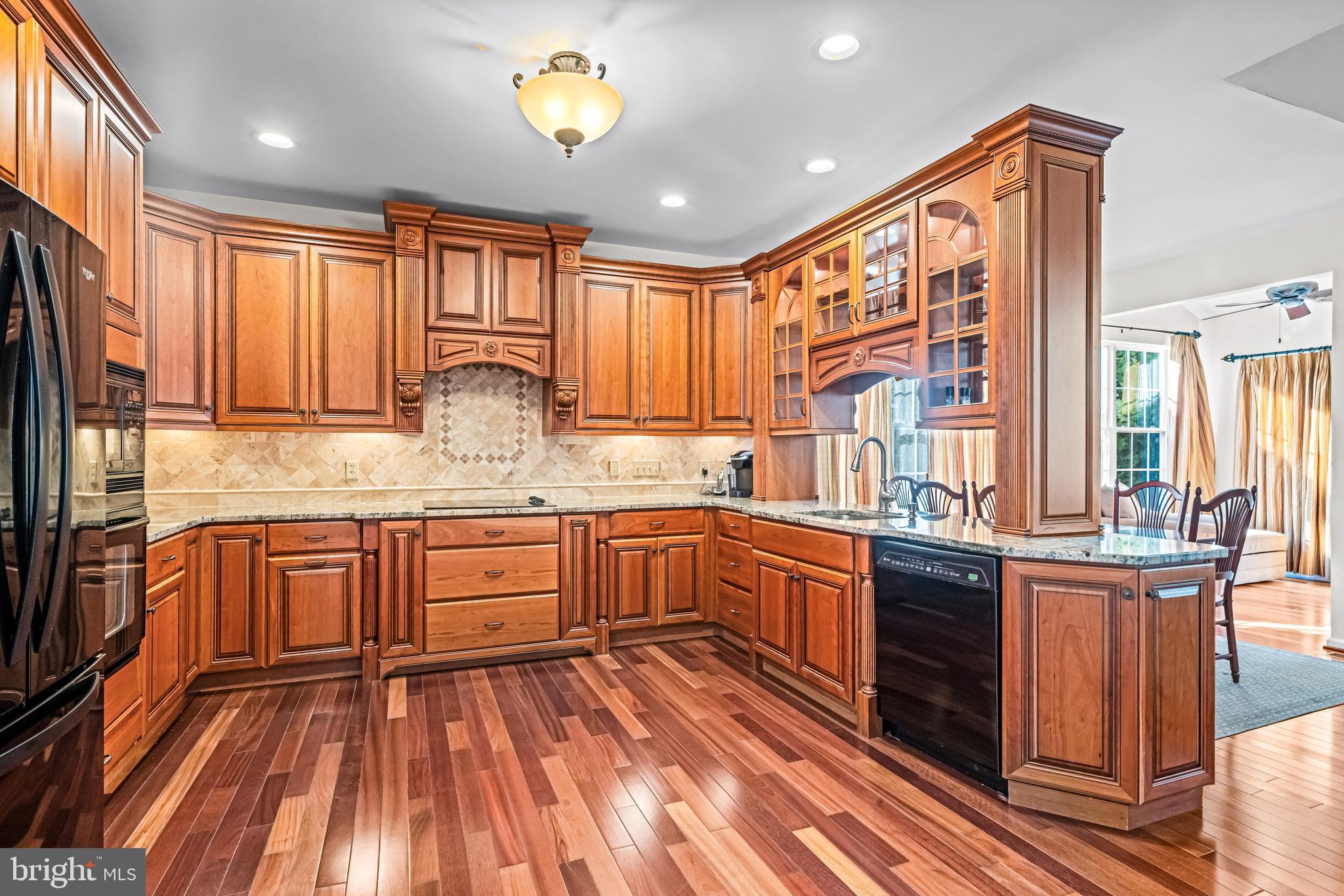 1200 Creekside Lane Quakertown, PA 18951 - Photo 5 of 37 a kitchen with stainless steel appliances granite countertop wooden cabinets and a stove top oven
