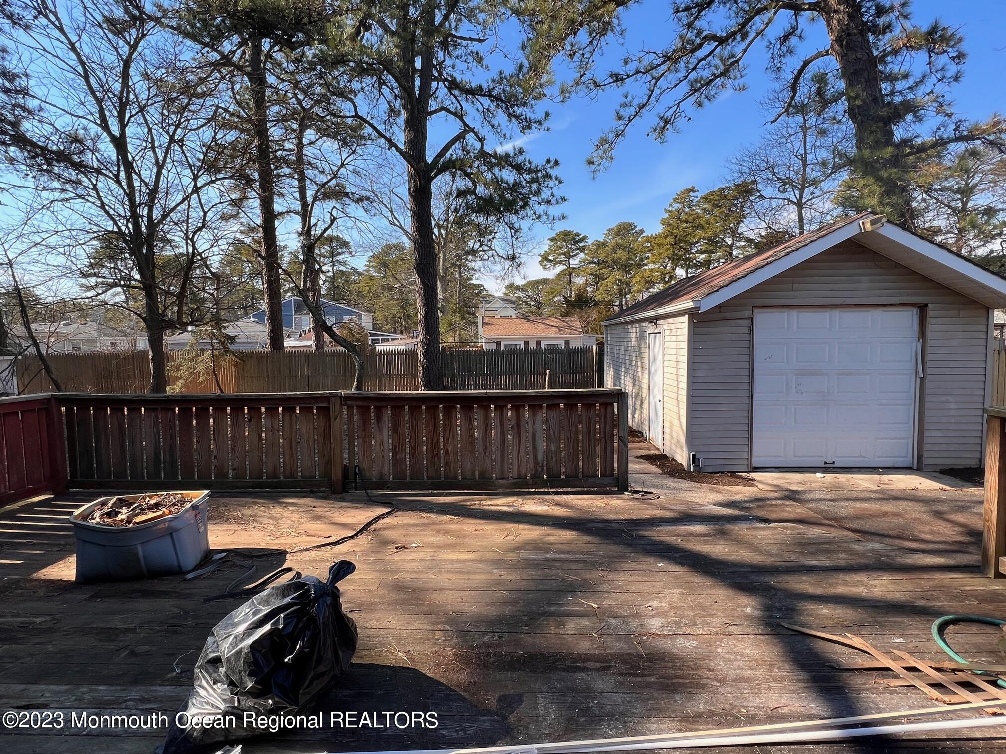 16 Walnut Street Waretown, NJ 08758 - Photo 11 of 12 a view of backyard with table and chairs and a fire pit