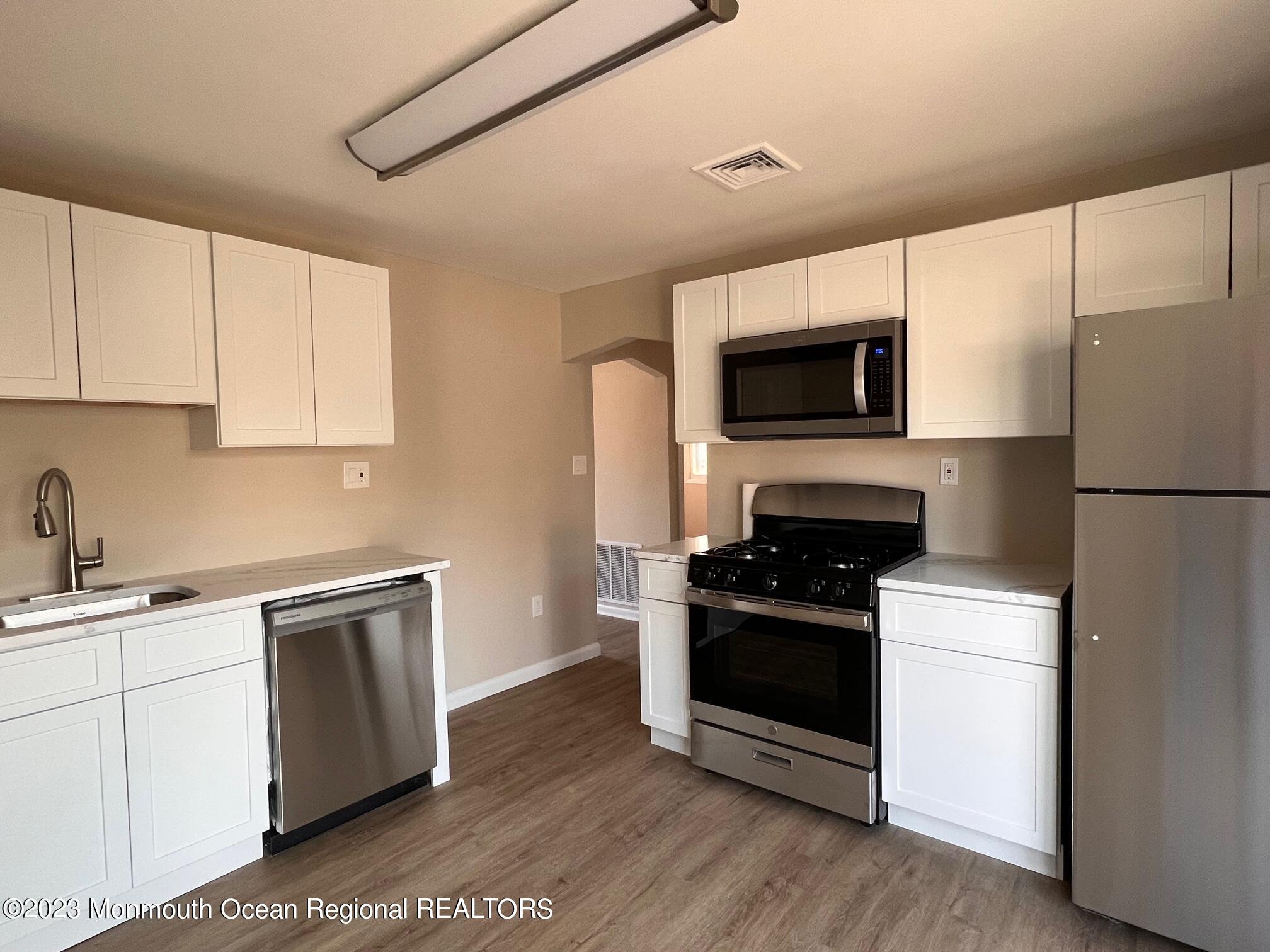 16 Walnut Street Waretown, NJ 08758 - Photo 12 of 12 a kitchen with a sink stove and refrigerator