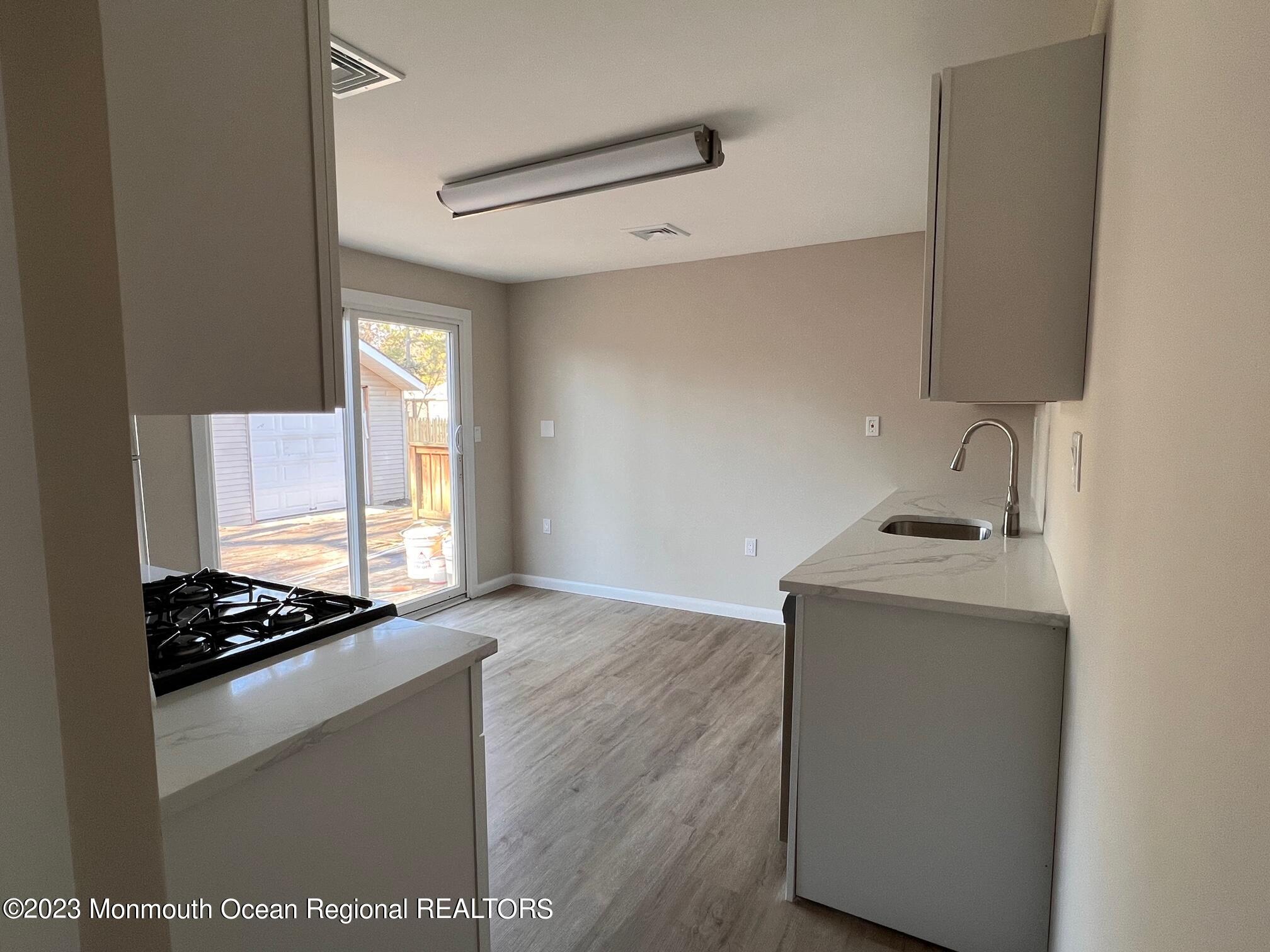 16 Walnut Street Waretown, NJ 08758 - Photo 6 of 12 a kitchen with granite countertop a sink and a stove