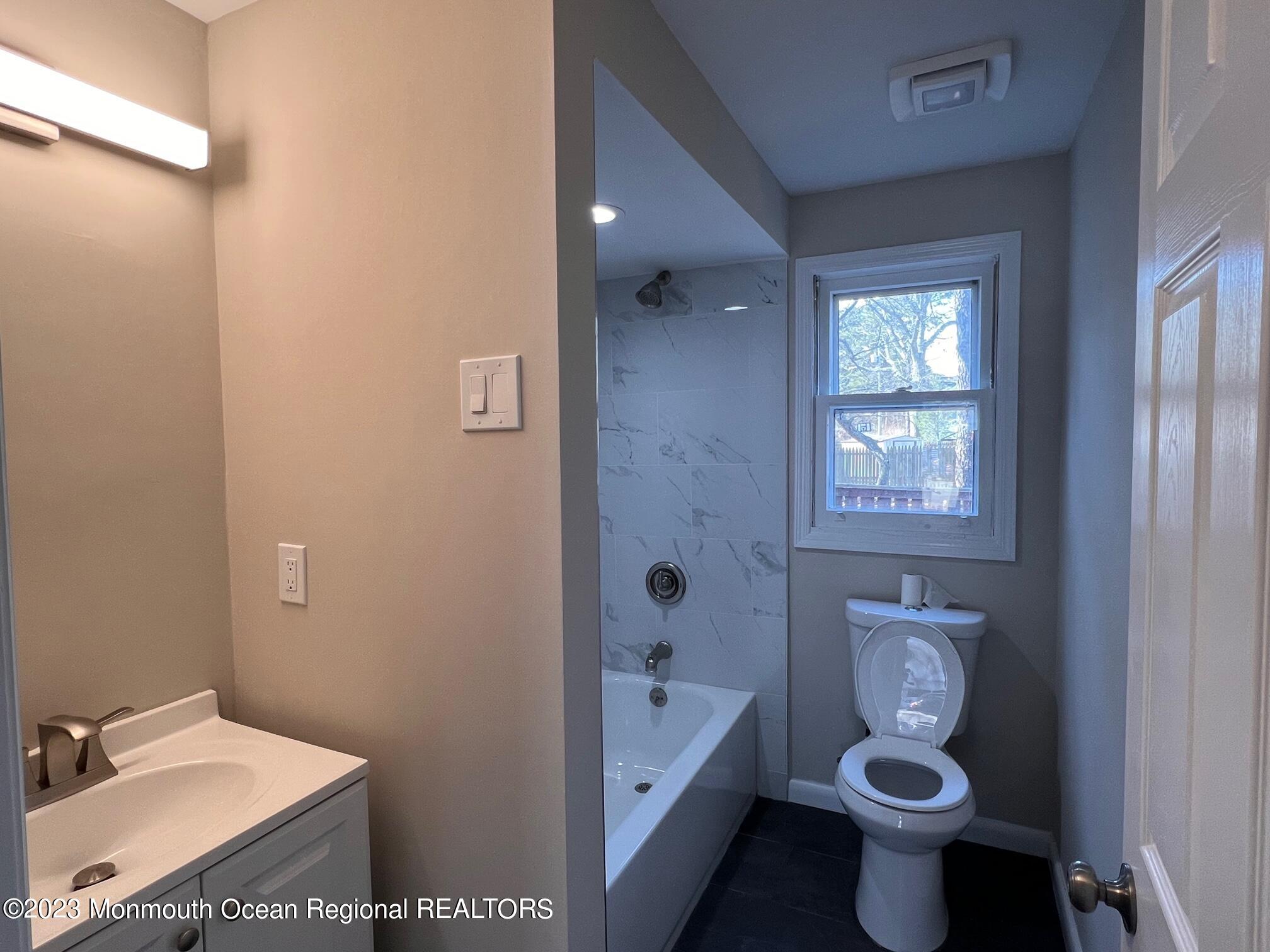 16 Walnut Street Waretown, NJ 08758 - Photo 7 of 12 a bathroom with a sink a toilet and shower