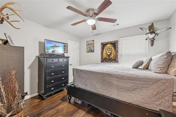a spacious bedroom with a bed and a fireplace