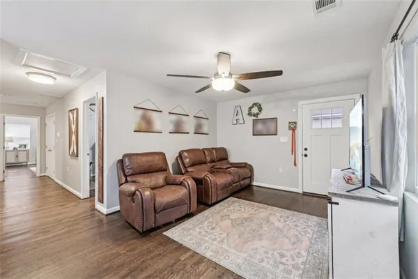 a living room with furniture and a flat screen tv