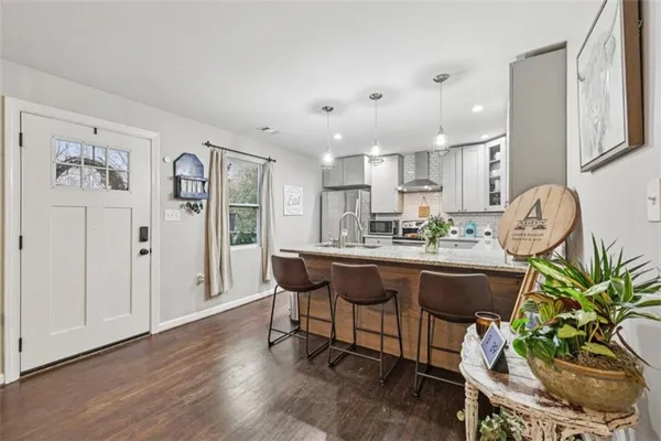 a kitchen with a refrigerator sink and white cabinets