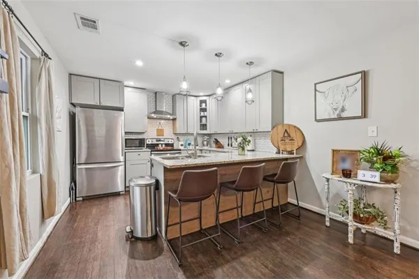 a kitchen with a sink stove and cabinets
