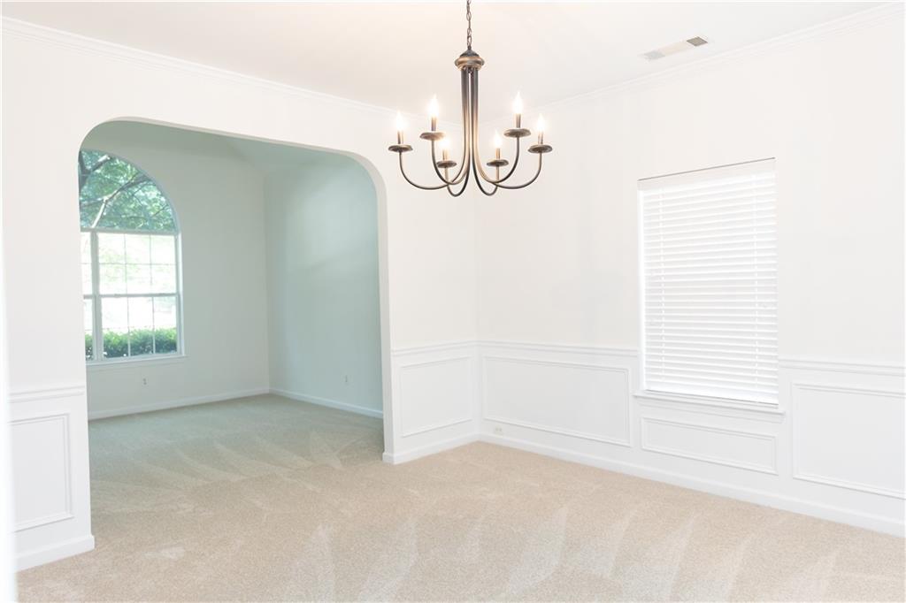 502 Streamside Place Canton, GA 30115 - Photo 8 of 33 an empty room with windows and entrance