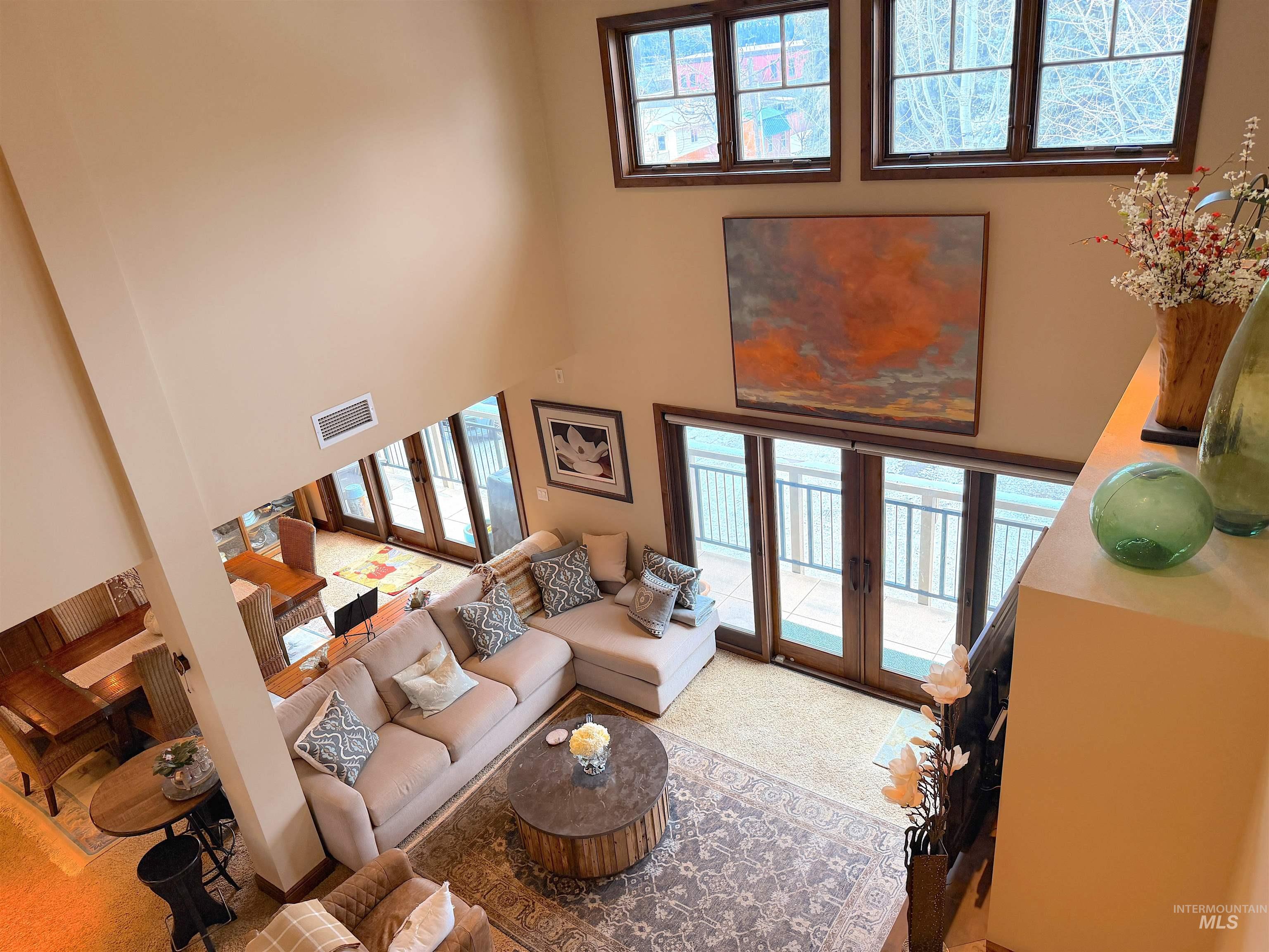 616 North 3rd Street, Unit 211 McCall, ID 83638 - Photo 17 of 49 Living room featuring french doors, carpet floors, and a high ceiling