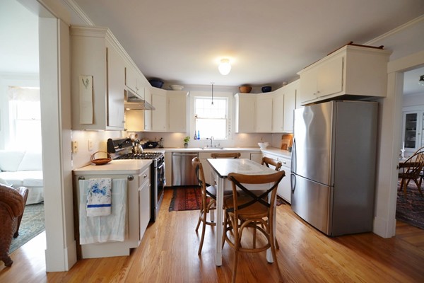 6 Pine Ridge Road Wellesley, MA 02481 - Photo 5 of 11 a kitchen with stainless steel appliances granite countertop a refrigerator a sink a stove a dining table and chairs