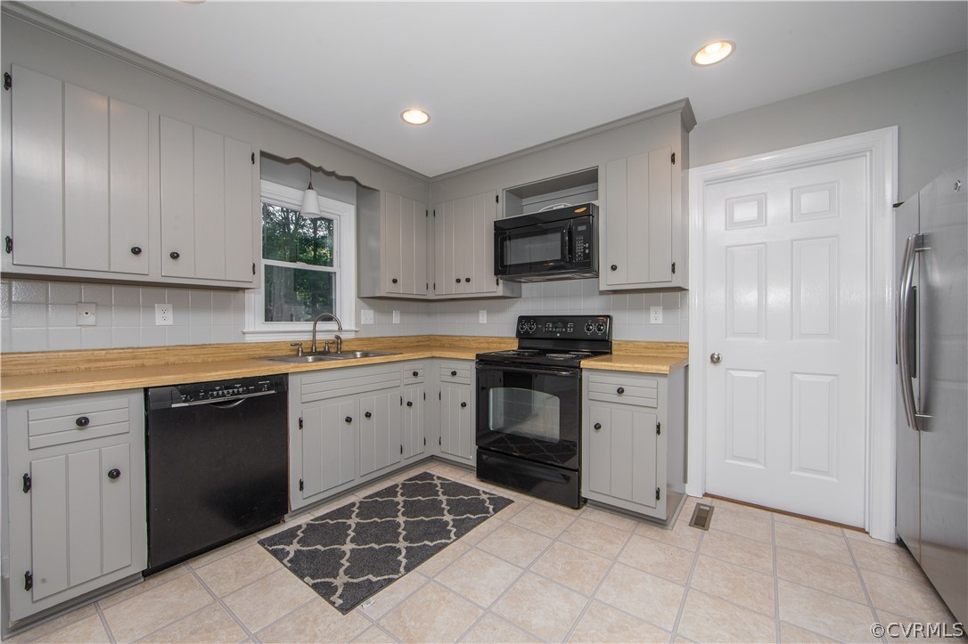 14200 Chepstow Road Midlothian, VA 23113 - Photo 21 of 41 a kitchen with a sink stove and microwave