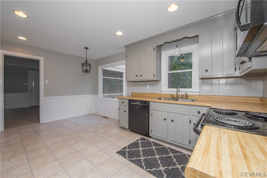 14200 Chepstow Road Midlothian, VA 23113 - Photo 23 of 41 a kitchen with stainless steel appliances granite countertop a sink and a stove top oven