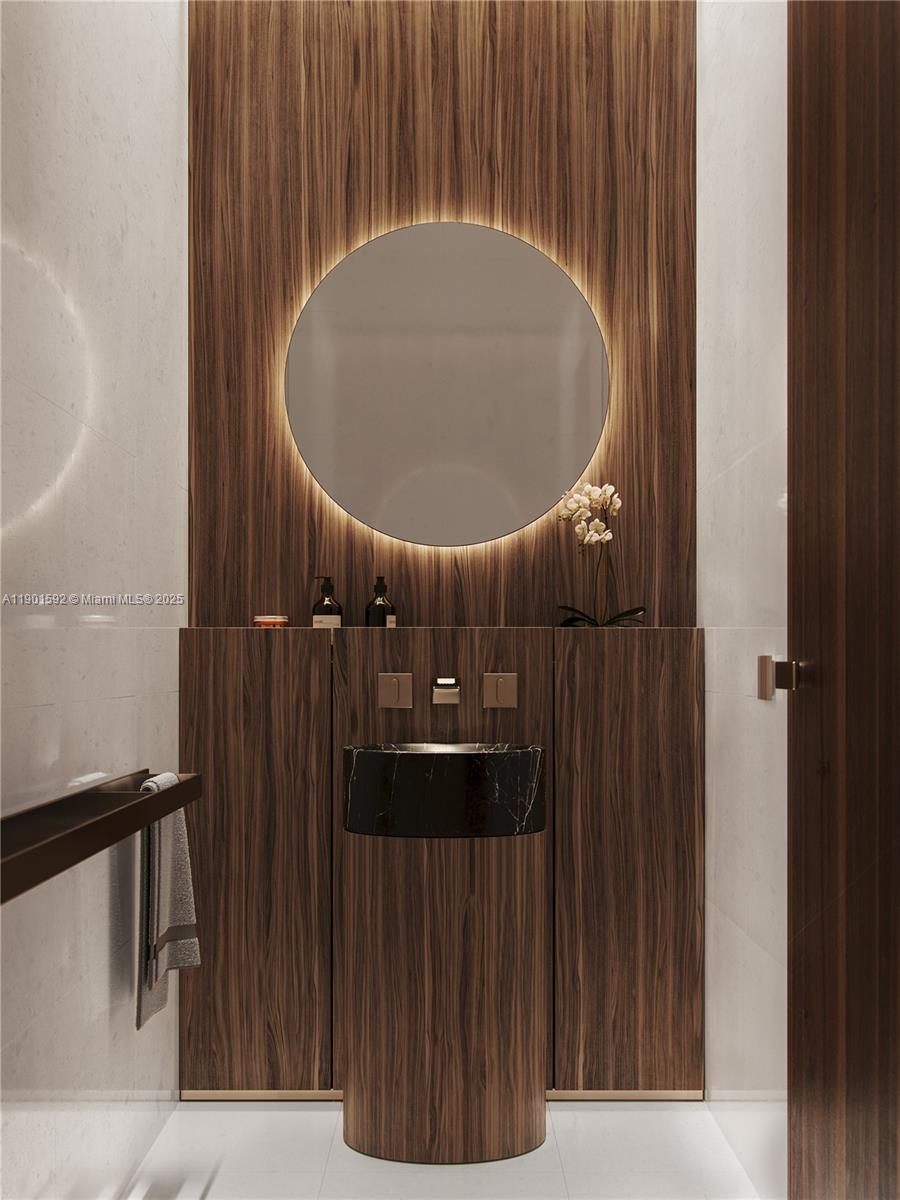 5 Grove Isle Drive, Unit S502 Coconut Grove, FL 33133 - Photo 4 of 19 a bathroom with a sink and a mirror