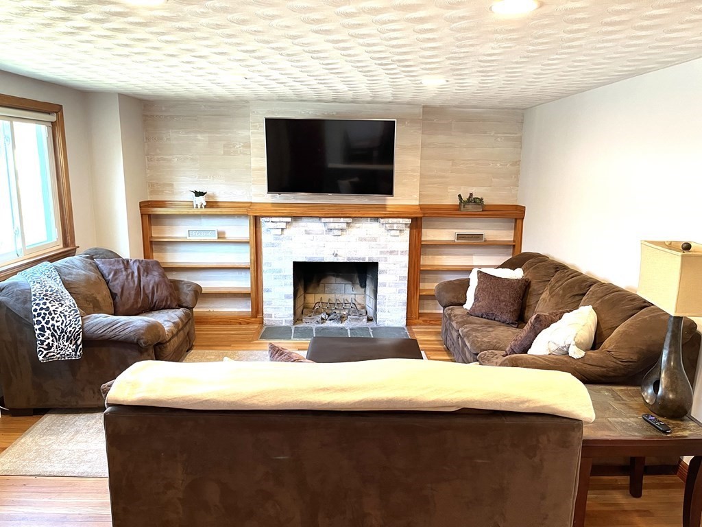 41 Lelland Road Stoughton, MA 02072 - Photo 11 of 29 a living room with furniture and a fireplace