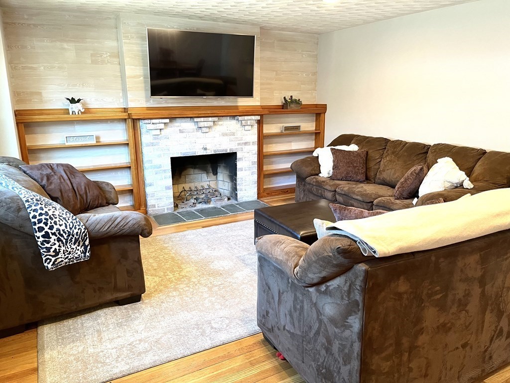41 Lelland Road Stoughton, MA 02072 - Photo 12 of 29 a living room with furniture and a flat screen tv