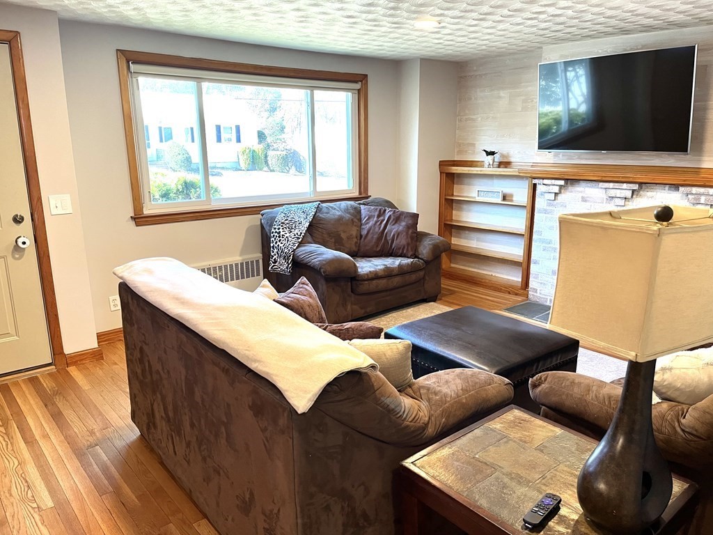 41 Lelland Road Stoughton, MA 02072 - Photo 13 of 29 a living room with furniture and a flat screen tv