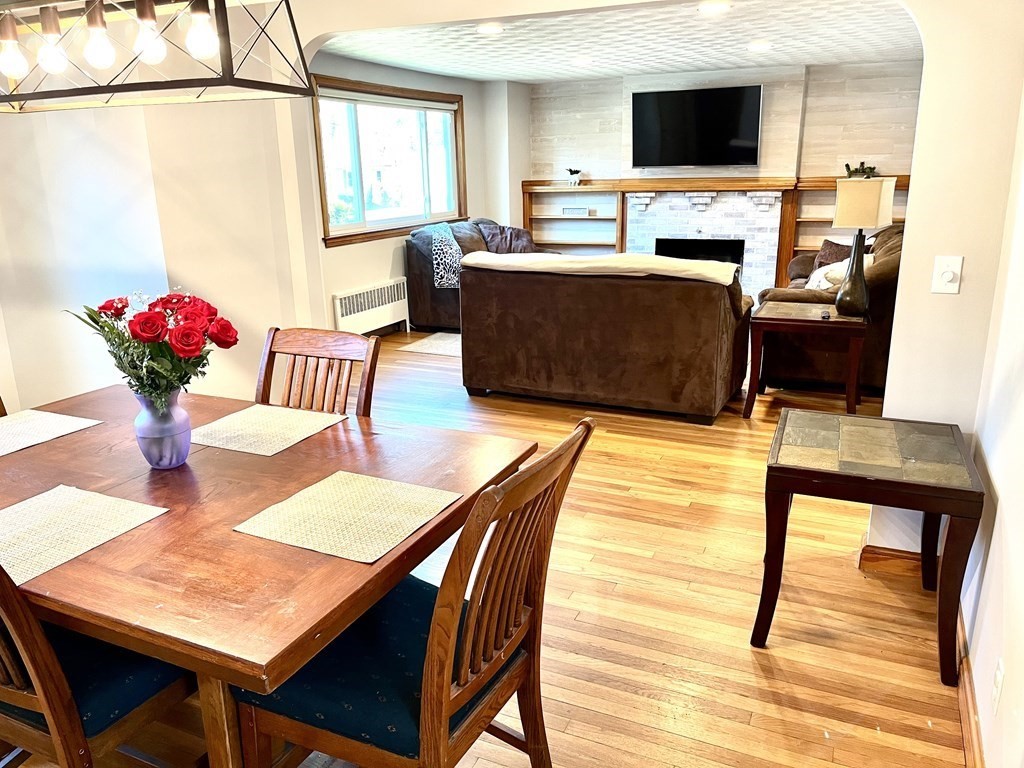 41 Lelland Road Stoughton, MA 02072 - Photo 14 of 29 a view of a dining room with furniture a chandelier and wooden floor