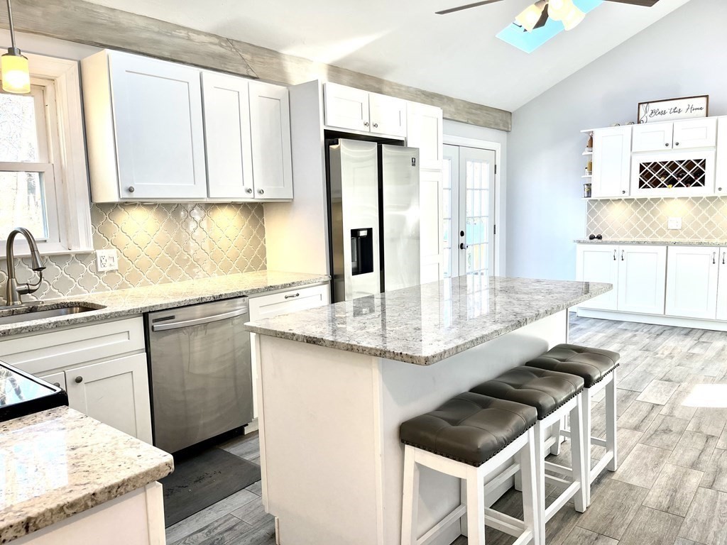 41 Lelland Road Stoughton, MA 02072 - Photo 3 of 29 a kitchen with granite countertop a sink stove and refrigerator