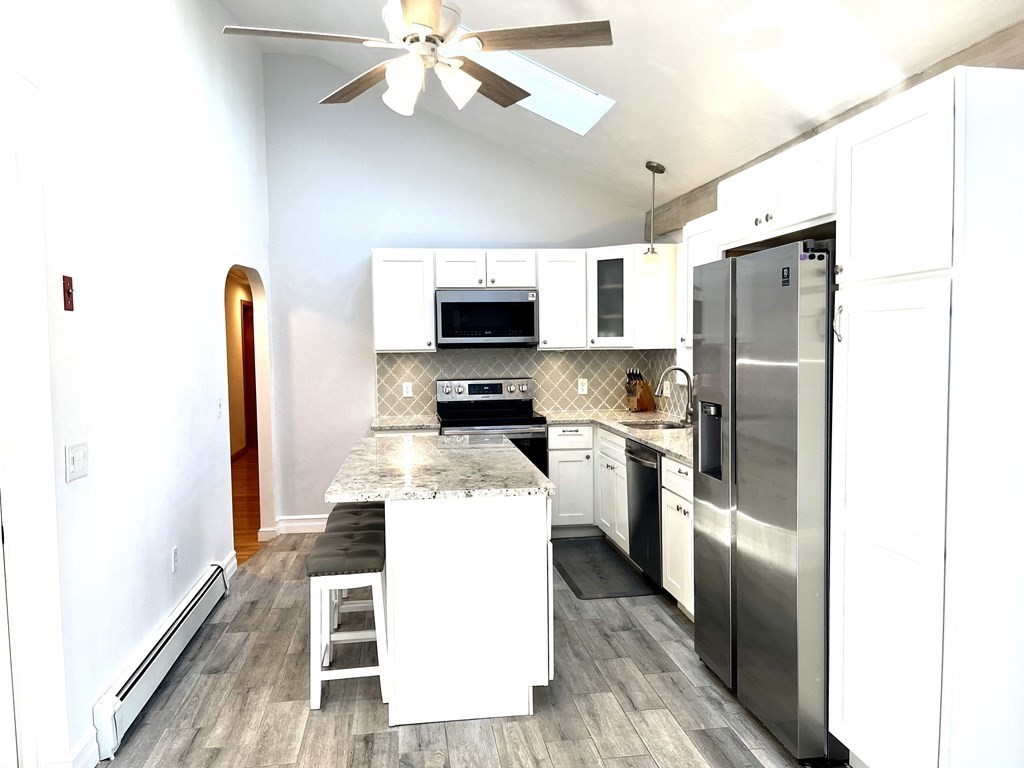 41 Lelland Road Stoughton, MA 02072 - Photo 6 of 29 a kitchen with a refrigerator a microwave oven a sink and dishwasher