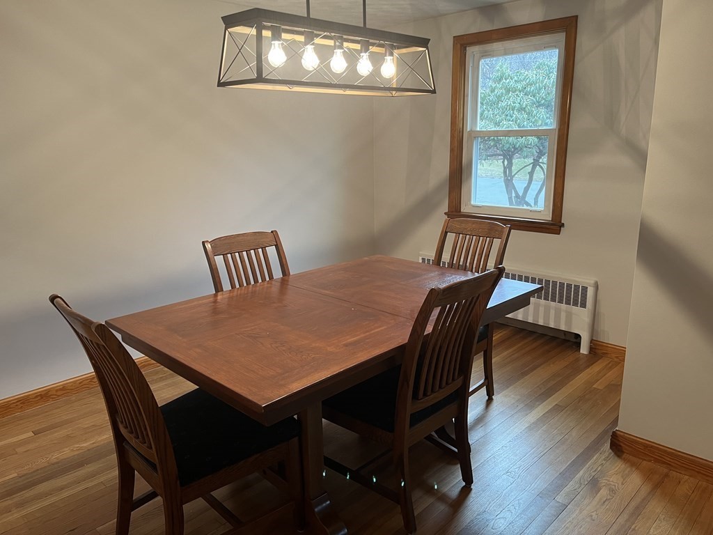 41 Lelland Road Stoughton, MA 02072 - Photo 10 of 29 a view of a dining room with furniture a chandelier and wooden floor