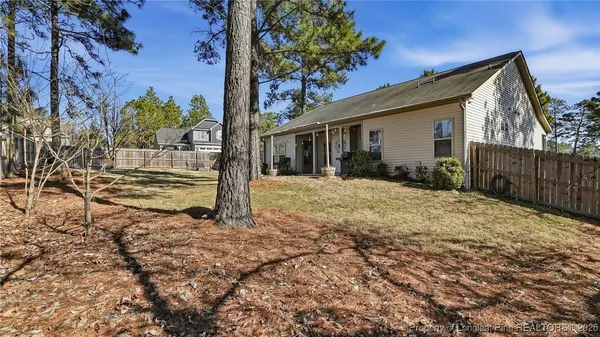 a view of a house with a yard and tree s