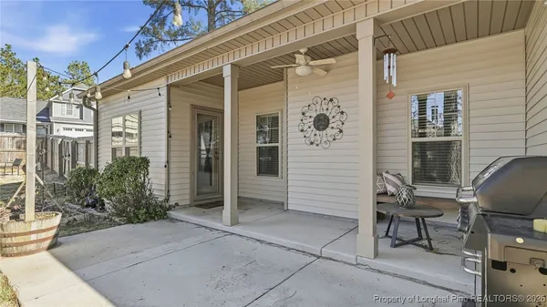 a view of a house with backyard and sitting area