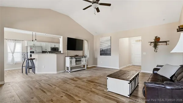 a living room with furniture and a flat screen tv