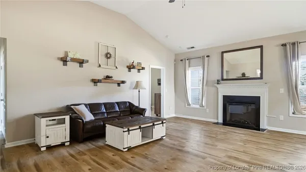 a living room with furniture and a fireplace