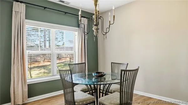 a view of a room with a table and chairs
