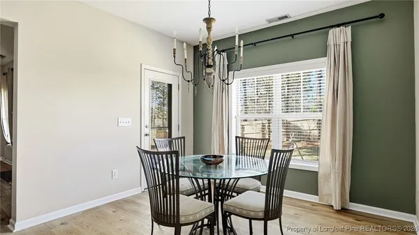 a view of a dining room with furniture window and outside view