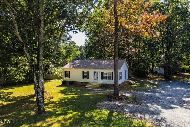 a house view with swimming pool in front of it