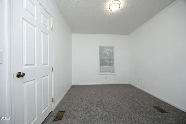 an empty room with a empty space and windows