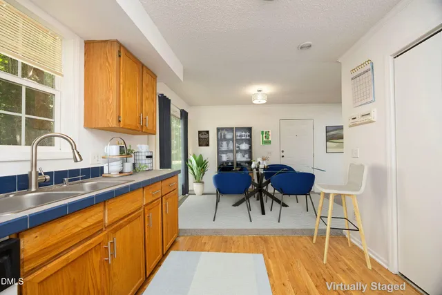 a view of a kitchen with kitchen island dining table and chairs