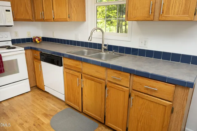 a kitchen with granite countertop cabinets stainless steel appliances and a counter space