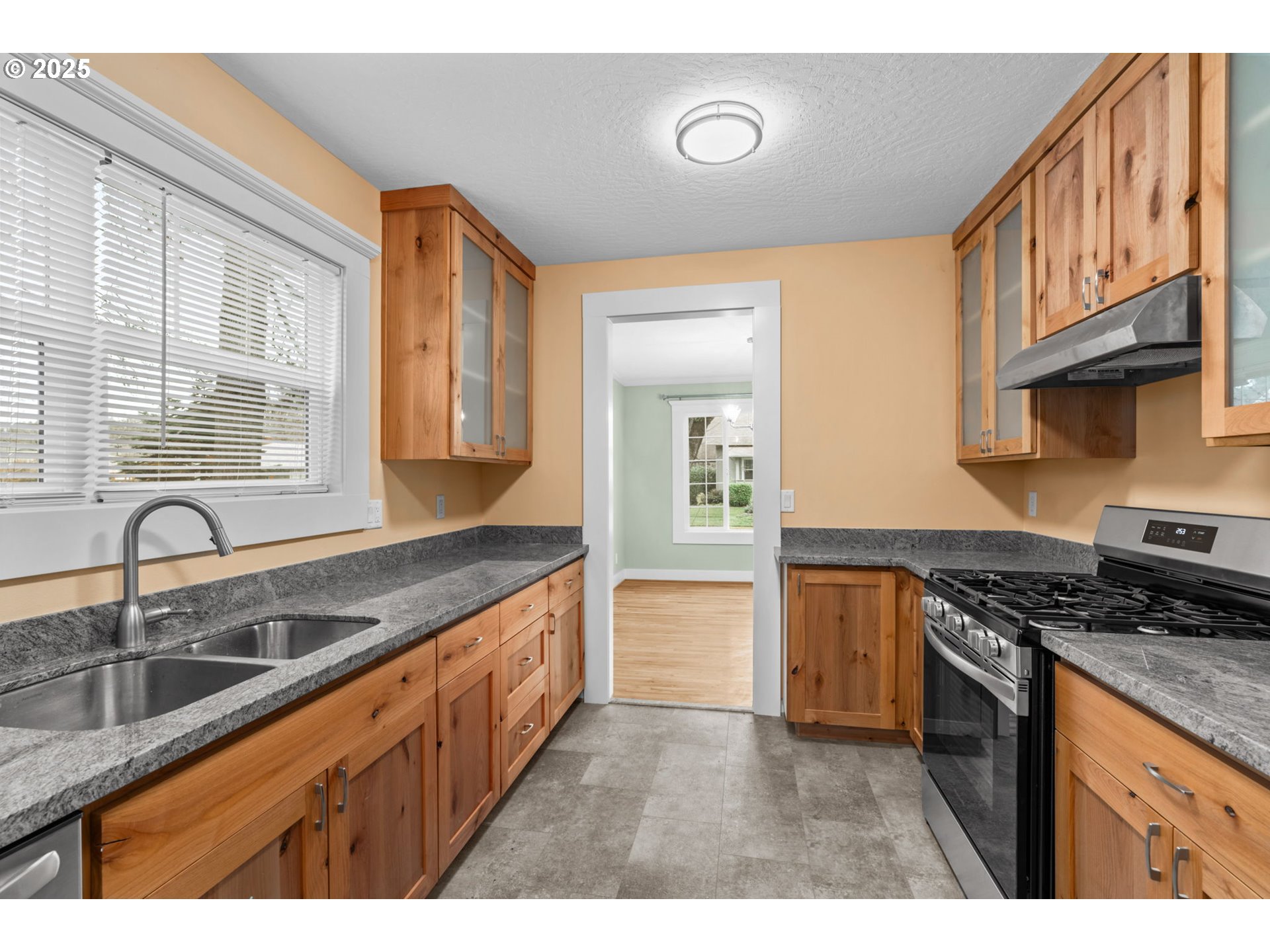 1010 Monroe Street Eugene, OR 97402 - Photo 11 of 40 a kitchen with granite countertop a sink a stove and cabinets