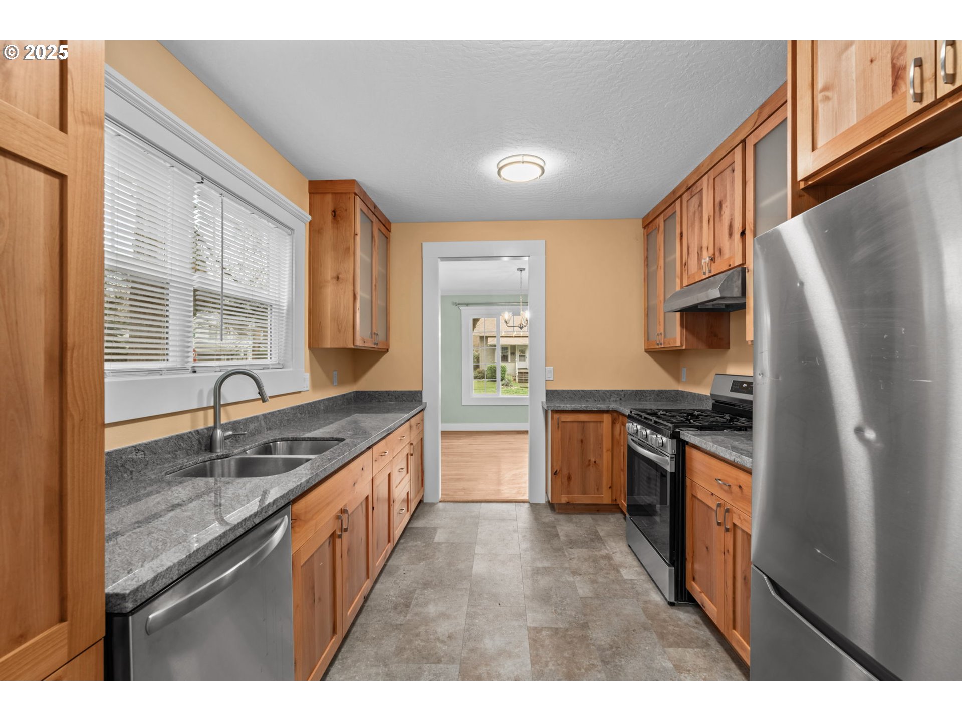 1010 Monroe Street Eugene, OR 97402 - Photo 12 of 40 a kitchen with granite countertop a sink stove and refrigerator