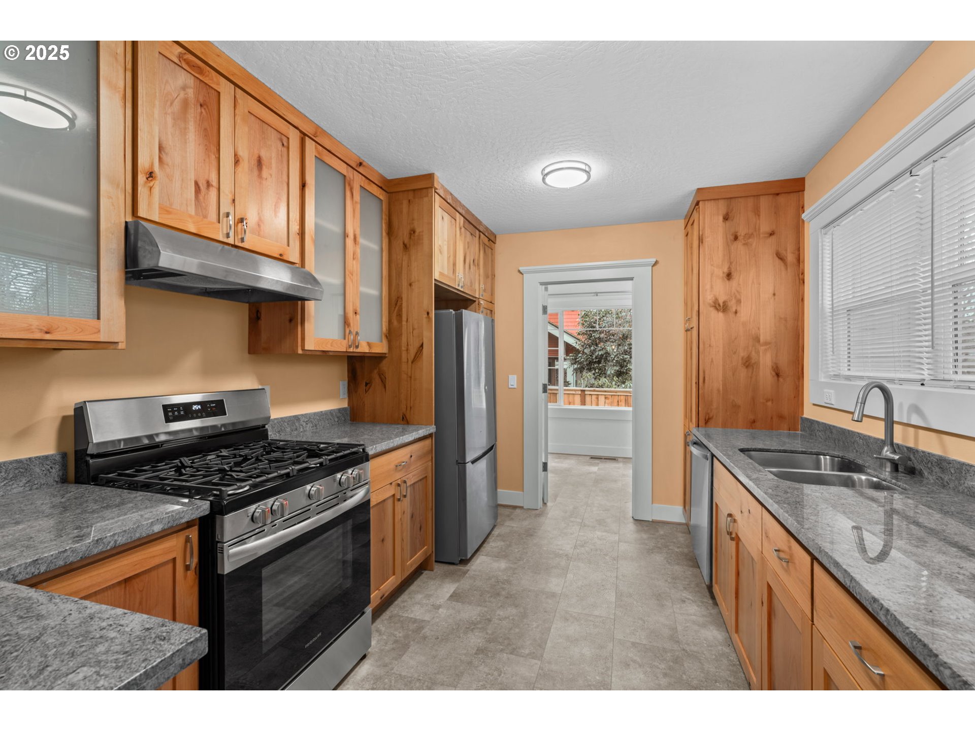 1010 Monroe Street Eugene, OR 97402 - Photo 13 of 40 a kitchen with stainless steel appliances granite countertop a stove a sink and a refrigerator