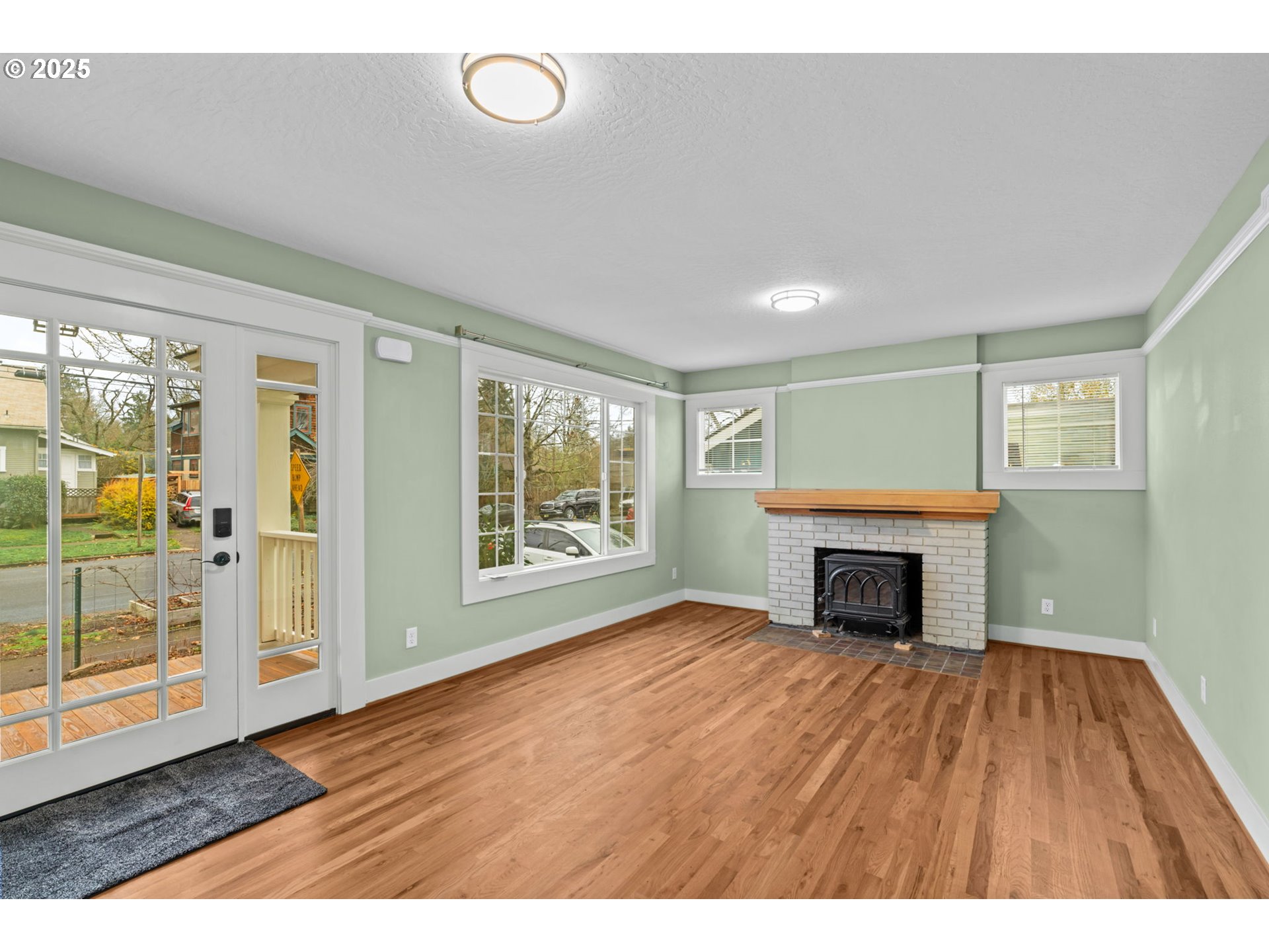 1010 Monroe Street Eugene, OR 97402 - Photo 5 of 40 a view of empty room with wooden floor and fireplace