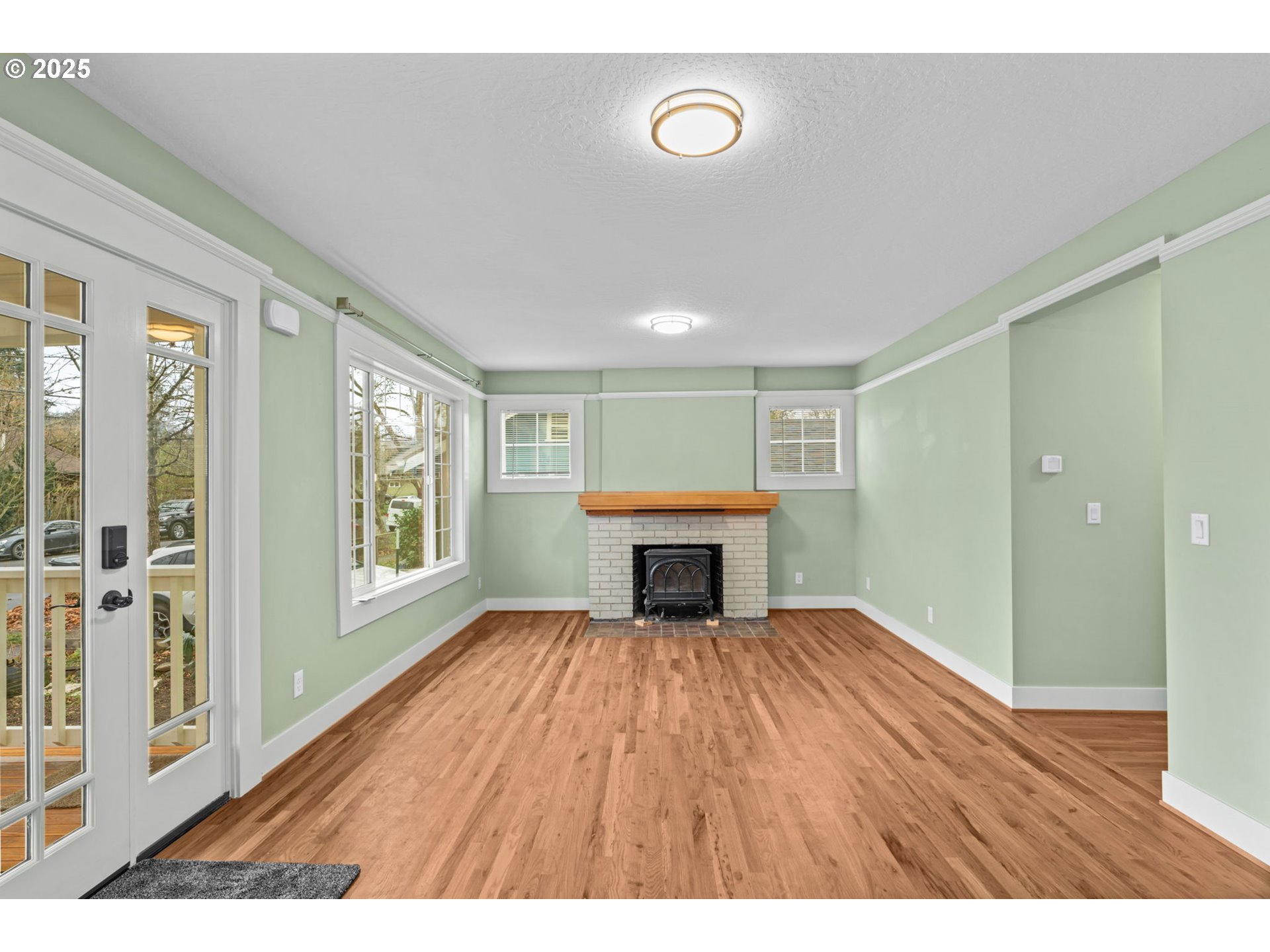 1010 Monroe Street Eugene, OR 97402 - Photo 6 of 40 a view of an empty room with wooden floor and a window