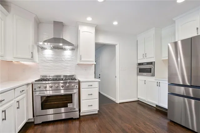 a kitchen with a stove and a refrigerator