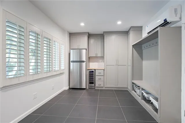a kitchen with stainless steel appliances a refrigerator and a stove top oven