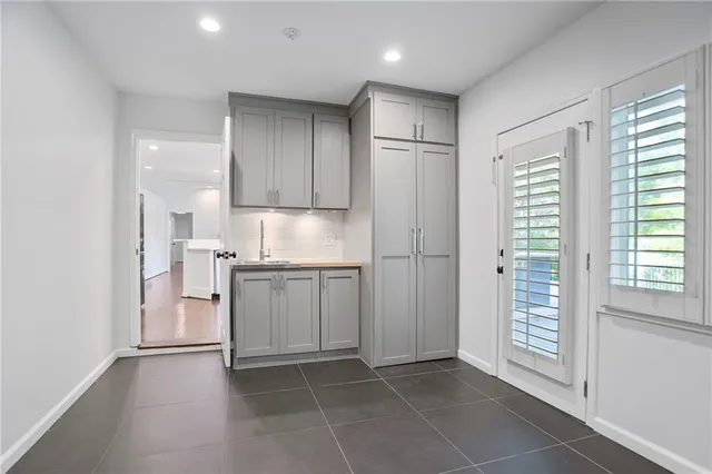 a kitchen with a refrigerator a sink and cabinets
