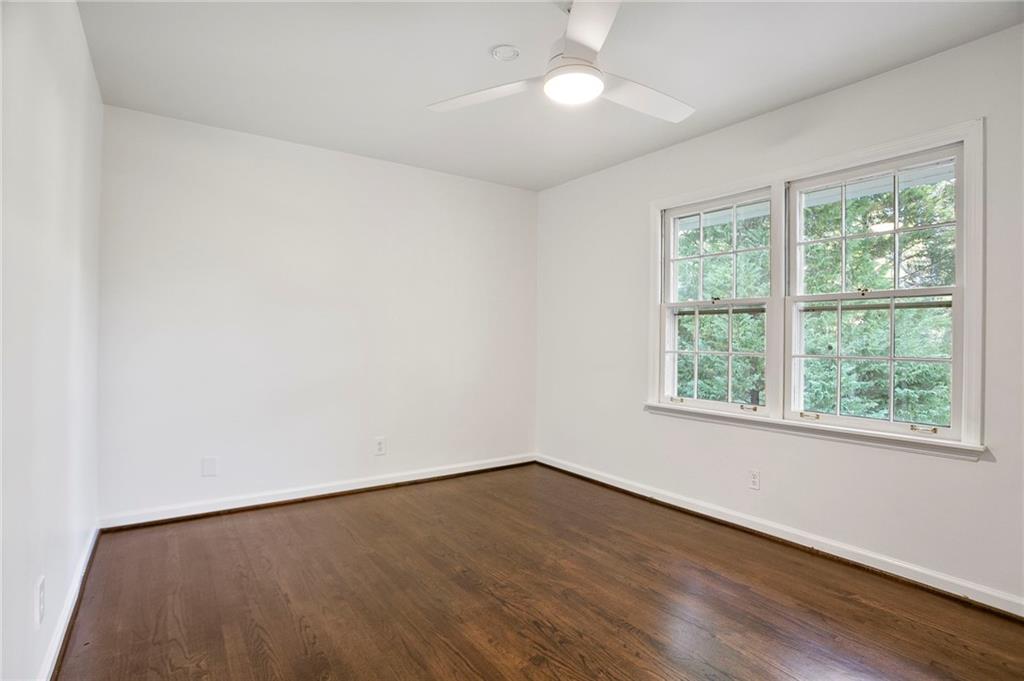 4555 Runnemede Road Northwest Atlanta, GA 30327 - Photo 17 of 51 an empty room with wooden floor and windows