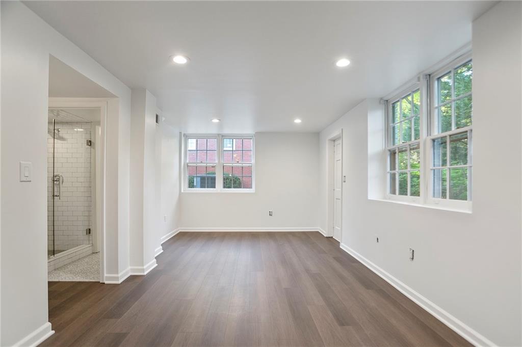 4555 Runnemede Road Northwest Atlanta, GA 30327 - Photo 26 of 51 an empty room with wooden floor and windows