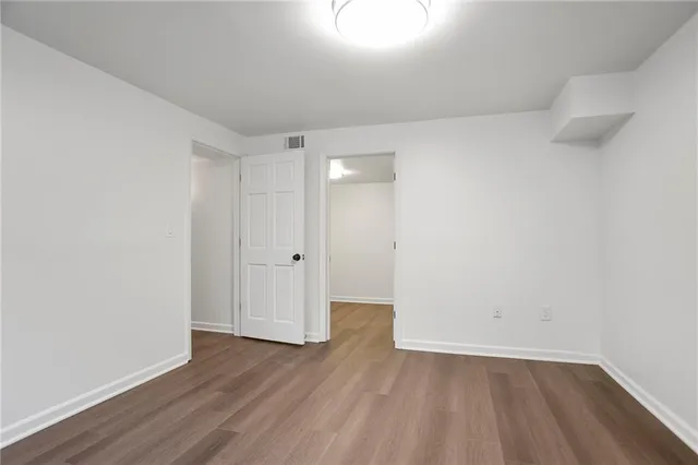 a view of an empty room and wooden floor