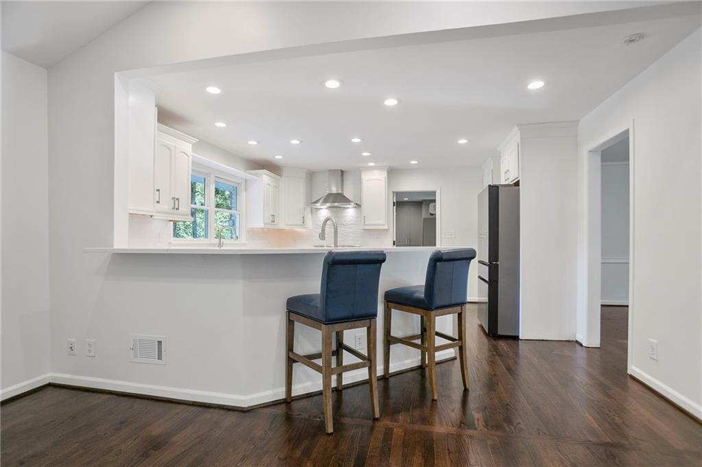 4555 Runnemede Road Northwest Atlanta, GA 30327 - Photo 10 of 51 a kitchen with a table and chairs in it