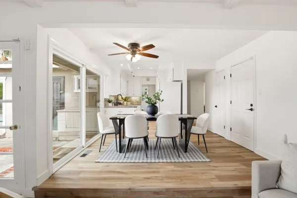 a view of a dining room with furniture and wooden floor