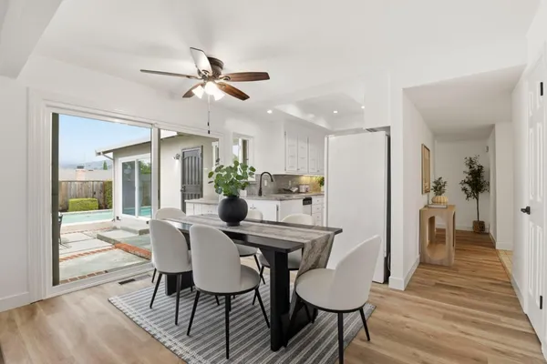 a view of a dining room with furniture and wooden floor