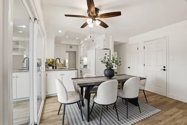 a view of a dining room with furniture and wooden floor