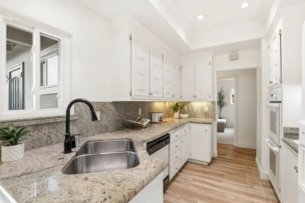 a kitchen with a sink cabinets and stainless steel appliances