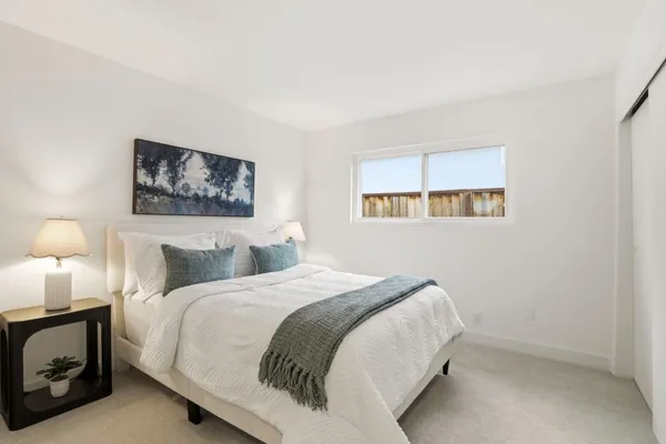 a bedroom with a bed and a window