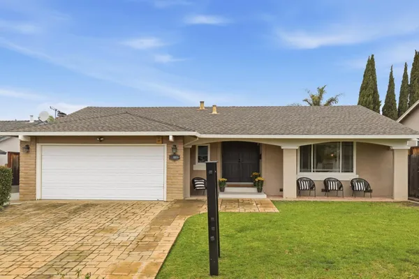 a front view of a house with garden